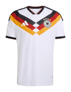 Germany 2026 home shirt front, white with black red gold diamond graphic